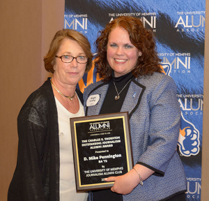 (Patsy) Pennington (left) accepts the University of Memphis Journalism Alumni Club’s Charles E. Thornton Award on behalf of her deceased husband, D. Michael Pennington, longtime trucking industry journalist and communication professional and a 1972 UofM graduate, from Angela Golding (right), UofM Journalism Alumni Board president.