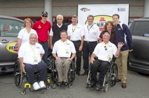Left to right: John Scott and his wife; Penske Racing driver Joey Logano; Roger Penske, owner of Penske Racing; Al Kovach Jr., national senior vice president, Paralyzed Veterans of America; Rusty Barron, vice president of marketing, Shell Lubricants; Istavan Kapitany, president of Shell Lubricants Americas; Hank Ebert and his wife; and Penske Racing driver Brad Keselowski unveil retrofitted vehicles, donated by Pennzoil through Paralyzed Veterans of America’s “Mission: ABLE” campaign on Saturday, Oct. 12 at Charlotte Motor Speedway.