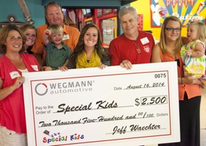 WEGMANN automotive donated $2,500 to Special Kids of Murfreesboro, Tenn., at the Perfect Equipment 75th anniversary celebration. Shown in the middle are Jennifer Dillon, Special Kids relations specialist, and Jeff Waechter, president and CEO of WEGMANN automotive USA Inc. surrounded by two Special Kids families