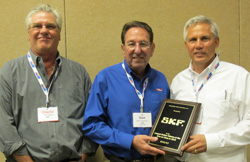 skf’s jeff guempel (right), automotive program group sales director, and charlie gilbert (left), regional manager, east, accept the largest total manufacturers’ orders at the 2010 one-on-ones award from apa president and ceo dan freeman (center).  