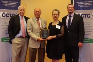 BASF employees Karl Schnapp (second from left), and Elaine Colyer accept the Eagle Award from (left) Dr. Kevin Swift, chief economist for the American Chemistry Council and Rob Paxton, OCTC board chair.