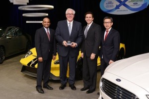 Ford's Raj Nair, Mark Fields and Hau Tai Tang present Bill Kozyra of TI Automotive (with trophy) with the Ford World Excellence Award for Quality for 2015.