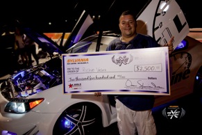 Richie Velez and his $2,500 prize for winning the Hottest Lighting Award at the HIN event in Orlando, sponsored by SYLVANIA Automotive Lighting and SilverStar zXe.
