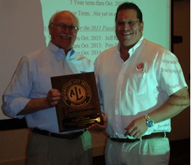 ALI President R. W. (Bob) O’Gorman (right) presents a service plaque to outgoing ALI Chairman Douglas Grunnet at the organization’s recent annual meeting.