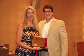 Standley receiving her award from from Nick Staub, APRA's Immediate Past Chairman