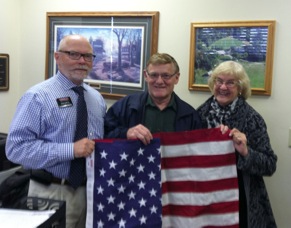 Darrell Amberson, ASA chairman, left, presents Bill Sauer, Identifix co-founder, with an American flag that was flown over the U.S. Capitol and a letter of recognition for his contributions to the automotive service industry. Sauer was joined by his wife, Duffy. 