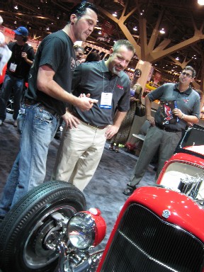 From left to right: Troy Ladd shows sweepstakes winner Vin Paladini his new Raybestos ’32 Roadster Pickup while Affinia's Josh Russell looks on.