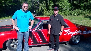 Tommy Baldwin and Rutlege Wood pose next to the custom muscle car.  