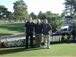   Photo – Aftermarket Foundation board members Richard Scovner, center (Tenneco Automotive) and Terry O’Reilly, right (Pricedex Software), take a pause from the Golf Tournament to pose with a DSR’s Scott Noth in front of Tony Schumacher’s US Army Top Fuel dragster