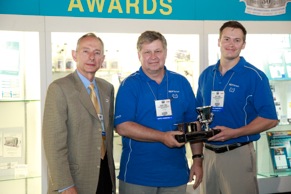 (Left to right) Stephen Bearden, AIA Chairman, presents award to Helmut Ernst and Steve Landis of Continental Corp. with the 