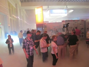 Conference attendees wade through the fog during the event's vendor expo.
